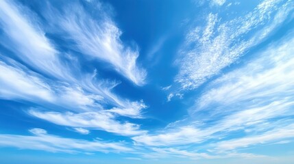 Beautiful bright blue sky with delicate wispy white cloud patterns