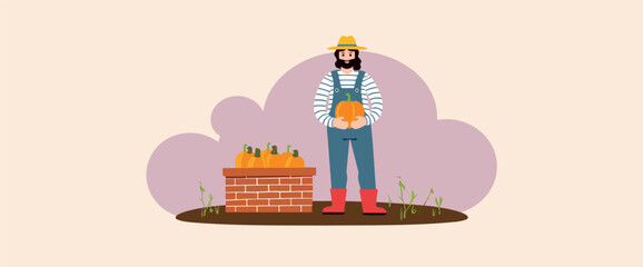Obraz premium cheerful farmer holding a pumpkin in front of a brick wall