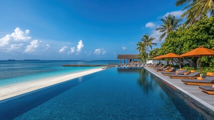 Fototapeta premium Serene Infinity Pool Overlooking Tropical Beach and Clear Blue Sky in a Relaxing Resort Setting