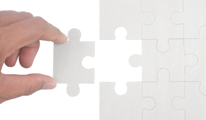 Placing missing puzzle piece indoor setting image of hand minimalist environment close-up view concept of completion