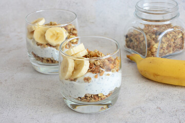 Healthy sugarfree snack with granola, chia seed, banana and yogurt
