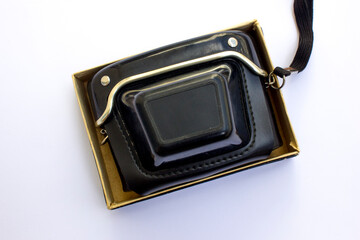 Black leather case for analog camera on white background.