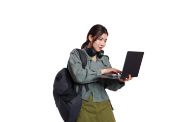 Portrait of Asian female student wearing backpack, headphones, fashionable clothes, holding laptop, posing dynamically on white background