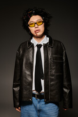 Fototapeta premium Stylish spring fashion featuring an asian man in a studio with a contemporary vibe