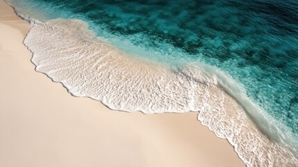 Aerial view of a beach featuring white sand and clear blue water.
