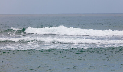 The ocean is calm and the waves are small