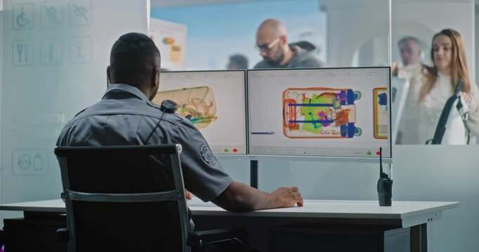 Airport Security Checkpoint: African American TSA Worker Controlling X-ray Metal Detector Scanning of Baggage on Computer Monitors. Diverse Passengers During Screening Procedure of Carry-On Luggage.