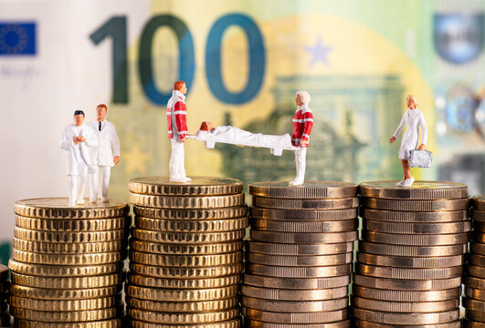 Figures from the healthcare sector on stacks of money in front of a one hundred euro bill