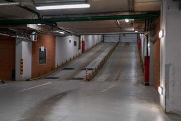 Underground Ascent: Entrance ramp to an indoor parking garage, industrial scenery.