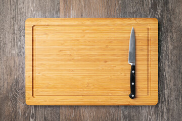 Empty cutting board with knife, top view