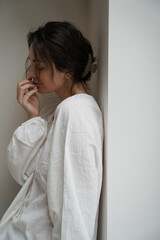 Introspective Woman in Relaxed Pose, Capturing Effortless Elegance