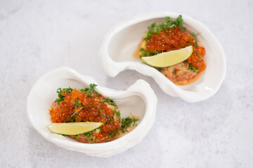 Delicious canapes with black and red caviar on wooden table