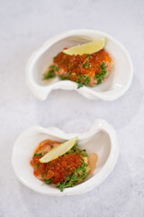 Delicious canapes with black and red caviar on wooden table