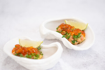 Delicious canapes with black and red caviar on wooden table