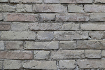A Full Frame Texture Shot Of A Light-Colored Brick Wall, Showing The Details And Patterns.