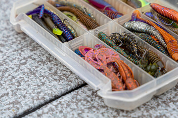 Fishing tackles and fishing baits in box .Classic Colored Fishing Lure , Beautiful Background...