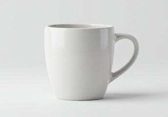 Fototapeta premium A simple white ceramic mug with a handle isolated on white background