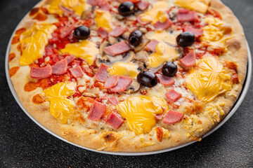 Pizza ham, mushrooms, olives, cheese appetizer vegetable dish fresh gourmet food background on the table rustic food top view copy space