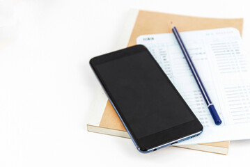 Mobile phone on Account book on whith background. Finance Savings and money wealth concept. Account Financial concept. Copy space for message.
