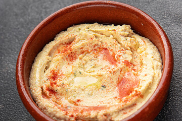 Hummus chickpea dip spices tasty appetizer vegetable dish fresh gourmet vegetarian and vegan food background on the table rustic food top view 