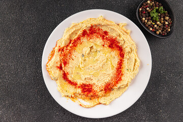 Hummus chickpea dip spices tasty appetizer vegetable dish fresh gourmet vegetarian and vegan food background on the table rustic food top view 