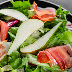 Salad pear ham vegetable dish fresh tasty gourmet food background on the table rustic food top view copy space
