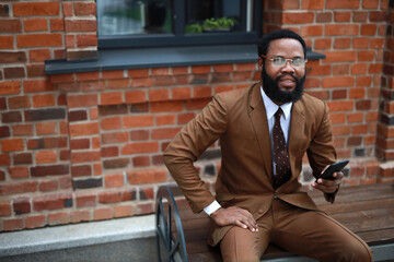 adult businessman in suit with mobile phone	