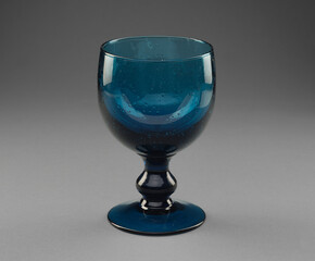 Elegant blue chalice glass on a stem, isolated on white background. Fine glassware showcasing luxury, sophistication, and minimalistic design for product or lifestyle photography.