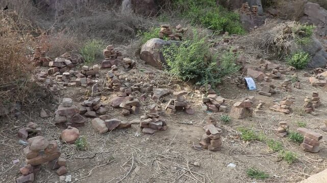 Temporary mini home-like structures made of bricks or stones near temples in Govardhan, Uttar Pradesh, symbolizing devotees&rsquo; wishes for a future dream home