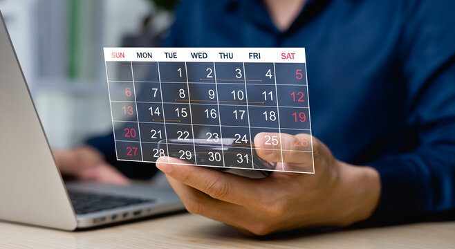 Businessman manages work time effectively, calendar on virtual screen interface, concept of tracking project plan, date and time of delivery to customer.