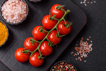 Red cherry tomatoes on a branch, a vegetable as an ingredient for making sauces