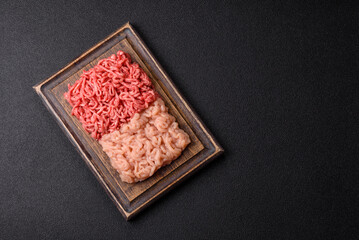 Beef and chicken minced meat, ground of two types fresh raw with salt and spices