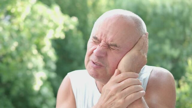 unhappy Senior man 60-65 years old holding painful ear, agony earache pain grimace, suffering from health problems, Tinnitus symptom, sharp pain issue, seeking relief