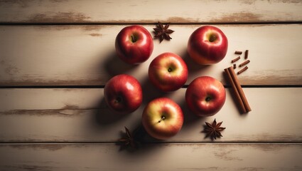 Still life, food and drink, seasonal theme. Autumn apples paired with spices on a wooden surface. Selective focus, copy space, top perspective.