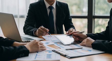A collaborative team of professionals meticulously reviewing financial data, strategizing over important business decisions in a modern, well-lit office setting.