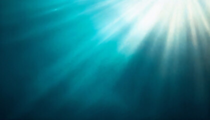 Underwater sunbeams pierce the deep teal water, creating a mesmerizing play of light and shadow.  