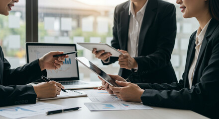 A team of confident businesswomen collaborating on a project, reviewing data and charts, demonstrating teamwork and strategic planning with soft lighting and a modern office setting.