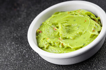 Guacamole dip avocado sauce vegetables dish organic fresh tasty gourmet food background on the table rustic food top view copy space 
