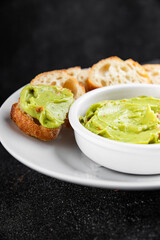 Guacamole dip avocado sauce vegetables dish organic fresh tasty gourmet food background on the table rustic food top view copy space 