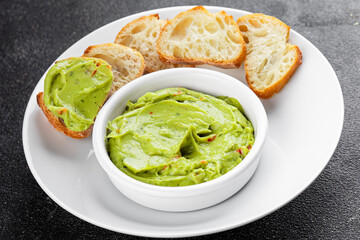 Guacamole dip avocado sauce vegetables dish organic fresh tasty gourmet food background on the table rustic food top view copy space 