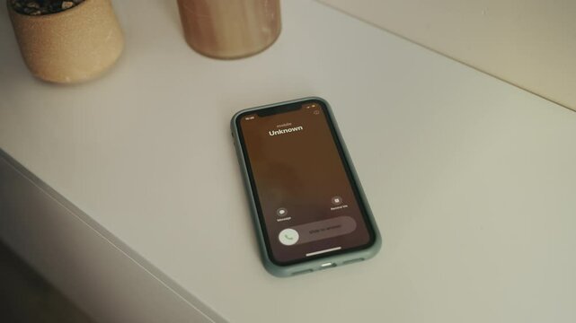 Close-up of elderly woman answering unknown call, suspicious phone scam attempt