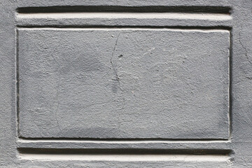 Gray concrete texture with lines. Symmetrical architectural detail. Rough surface pattern close up. Rectangular form on wall. Industrial background for design. Minimal construction element.