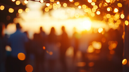 Group of blurred friends at a backyard bbq, enjoying a summer sunset evening with string lights and grilling food