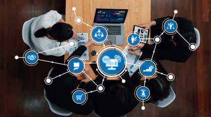A modern office setting showcasing a collaborative meeting where a team strategizes using technology and ERP systems for business integration and improvement. Amity