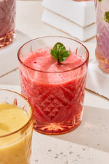 Vibrant Berry Smoothie in Elegant Glass with Mint Garnish in Sunlit Setting