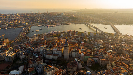 Aerial Galata Tower at Sunset. 
Galata Bridge and Golden Horn of Istanbul with beautiful colors at Sunset.
