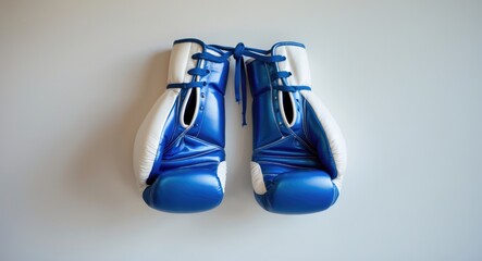 Hanging blue boxing gloves on the wall