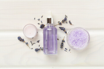 Obraz na płótnie Canvas Lavender spa cosmetic on wooden background, top view