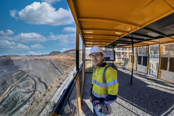 engineer miner worker, at the diamond open pit mine, overlooking the extraction process at the...