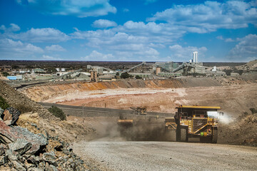 Open Pit Diamond Mining And Equipment , giant trucks on the gravel roads,